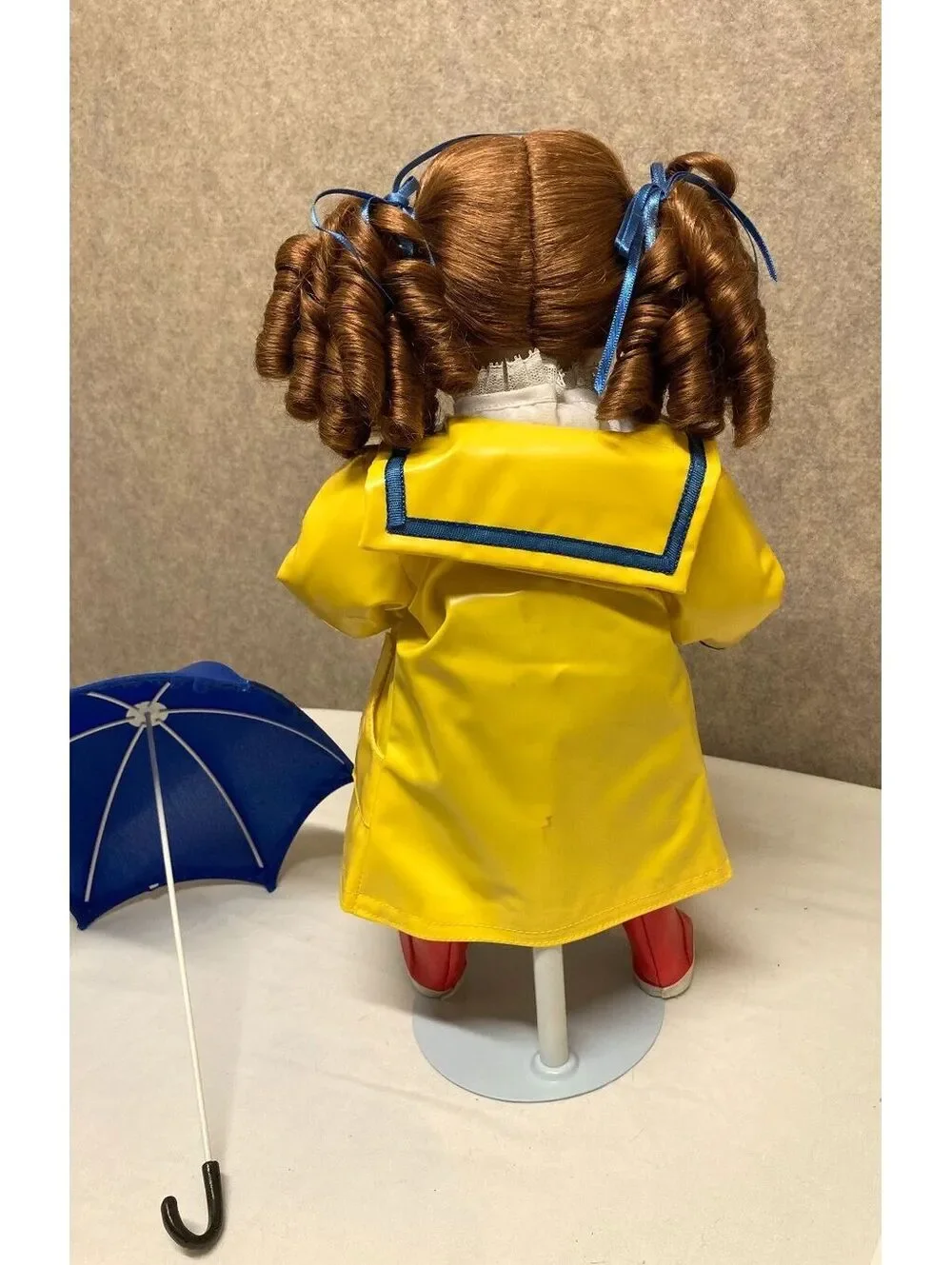 The Danbury Mint 'Kelly' Porcelain Doll with Blue Umbrella and Yellow Raincoat